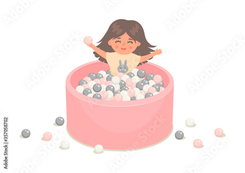 Little girl in soft pink pool full of plastic balls isolated on white background.