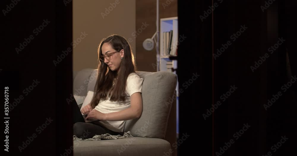 Young game blogger writes an article on a laptop at home Young game blogger writes an article on a laptop at home