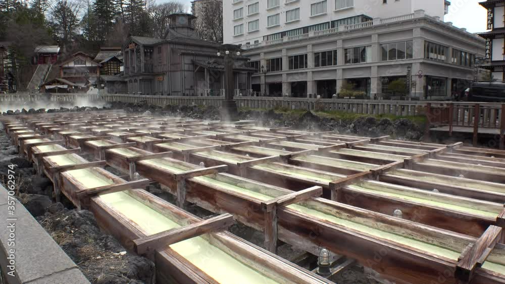 KUSATSU CITY, GUNMA, JAPAN - APR 2020 : Scenery of KUSATSU ONSEN town in day time. Japan's most famous hot spring resorts and popular tourist destination. View around Yubatake area (Hot spring field). KUSATSU CITY, GUNMA, JAPAN - APR 2020 : Scenery of KUSATSU ONSEN town in day time. Japan's most famous hot spring resorts and popular tourist destination. View around Yubatake area (Hot spring field).