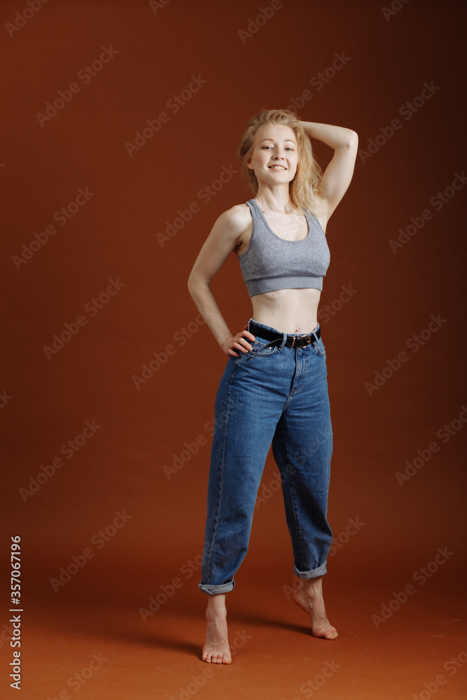 Model test with young beautiful blond woman on brown backdrop, isolated, natural Model test with young beautiful blond woman on brown backdrop, isolated, natural