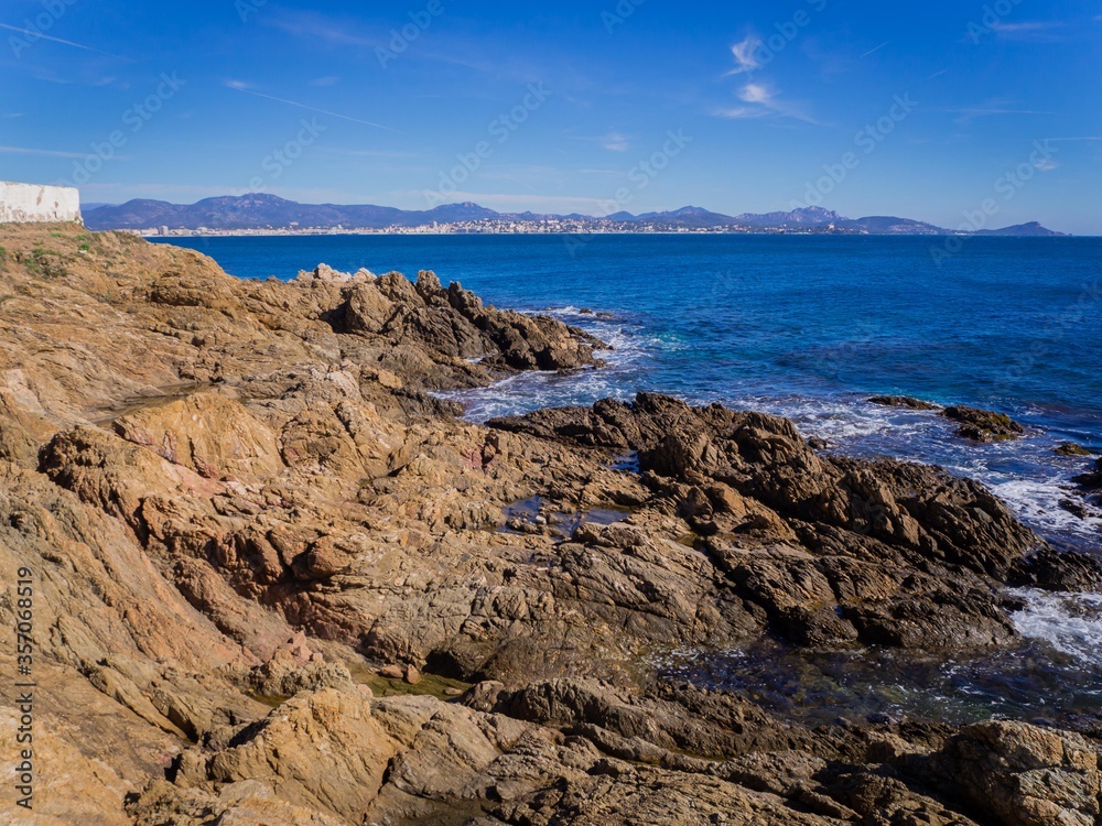 beautiful rocky coast, azure water and blue sky in Sunny weather in Saint Aygulf, France beautiful rocky coast, azure water and blue sky in Sunny weather in Saint Aygulf, France