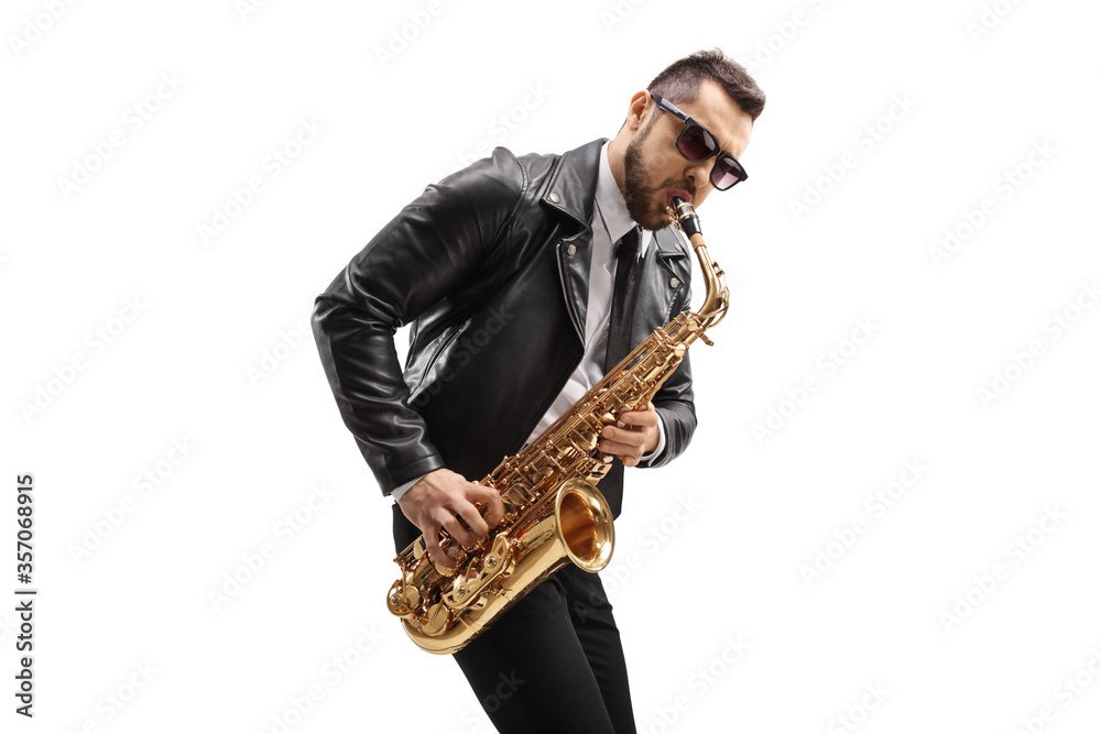 Fototapeta premium Male musician in a leather jacket wearing sunglasses and playing a saxophone