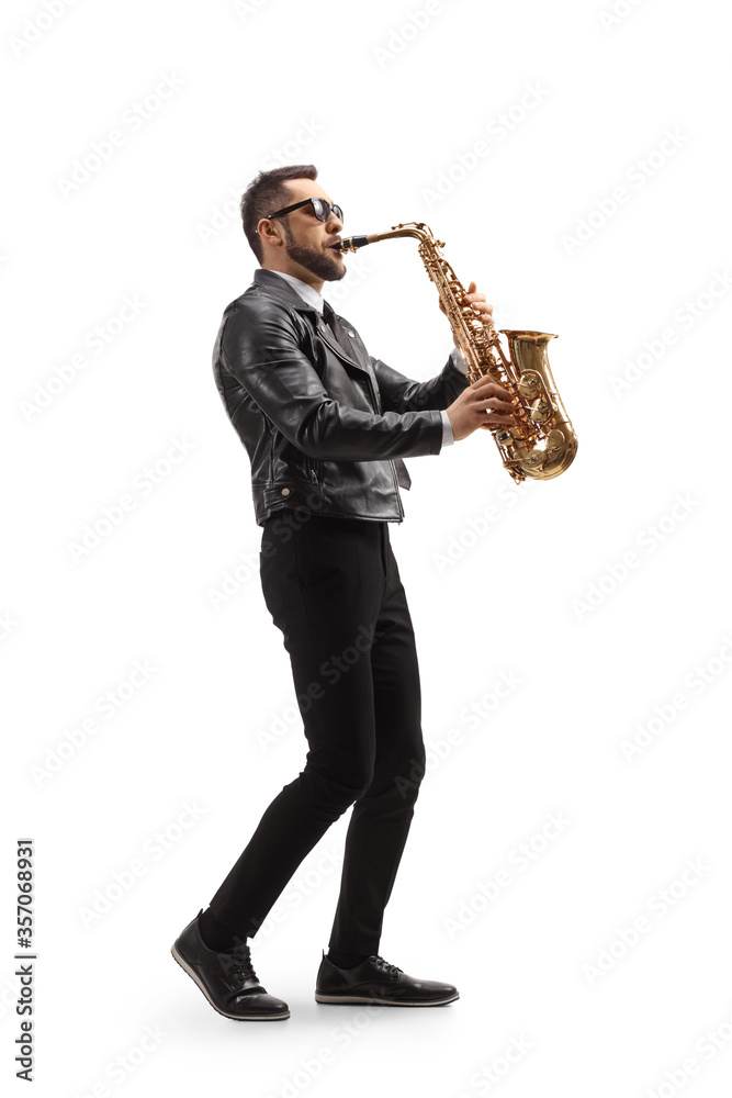 Naklejka premium Young handsome man playing a saxophone