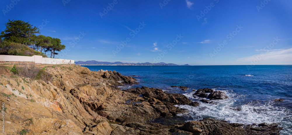 Panoramic view of beautiful rocky coast, azure water and blue sky in Sunny weather in Saint Aygulf, France