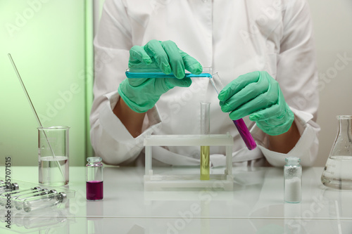 scientist hands doing chemical experiments in the laboratory close up