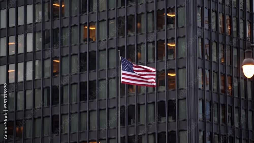 American Flag in front of Dark building. USA flag with stars and stripes American Flag in front of Dark building. USA flag with stars and stripes