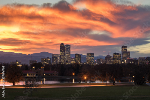 Denver Colorado skyline during sunset, with the Rocky Mountains visible in the background. 