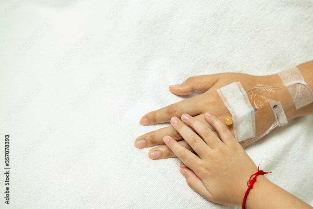 hand in hand, kid holding hand of old patient in hospital for Encouragement and concern. hand in hand, kid holding hand of old patient in hospital for Encouragement and concern.