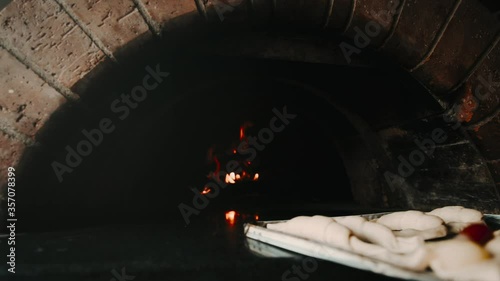 sweet croissant bread entering oven with fire