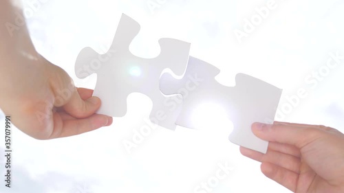 Appropriate for a particular person, purpose, or situation. Conceptual. Psychology of relationships. Logic, interconnection, teamwork. Puzzle pieces connected. Hand matching jigsaw halves Love concept