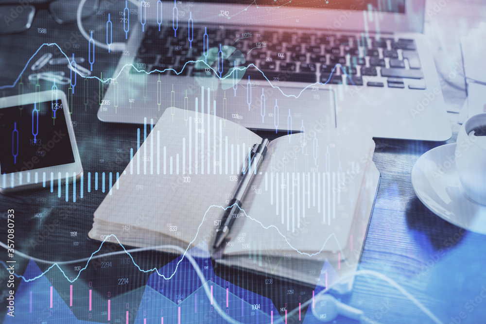 Multi exposure of financial graph drawings and desk with open notebook background. Concept of forex Multi exposure of financial graph drawings and desk with open notebook background. Concept of forex