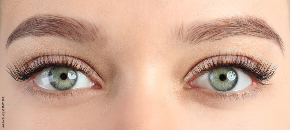 Young woman with beautiful eyelashes after extension procedure, closeup. Banner design - obrazy, fototapety, plakaty 