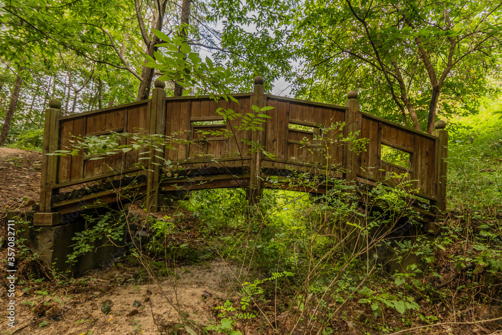Wooden foot bridge in a woodland park Wooden foot bridge in a woodland park