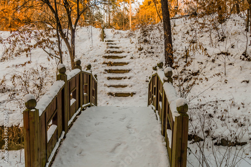 Photography Wintry landscape of wooden footbridge