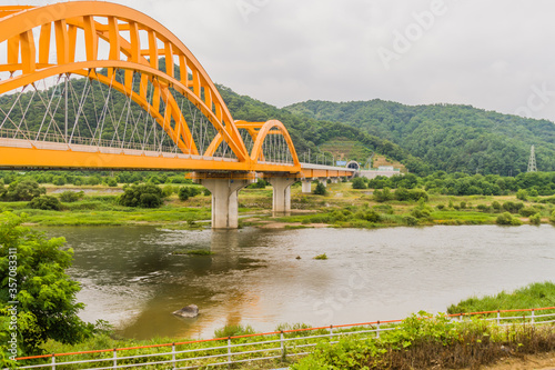 Yellow arched bridge over river