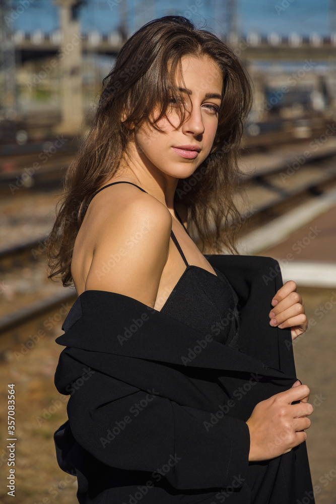 Portrait of young woman on the railroad station