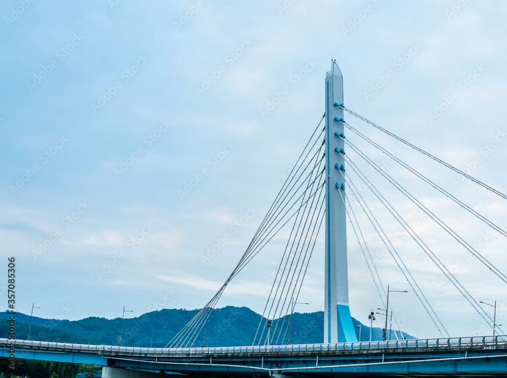 Bridge with a tall column extending into the morning sky