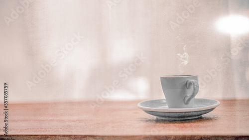 Hot Cup of Coffee or Tea on Wooden Table with blurred background