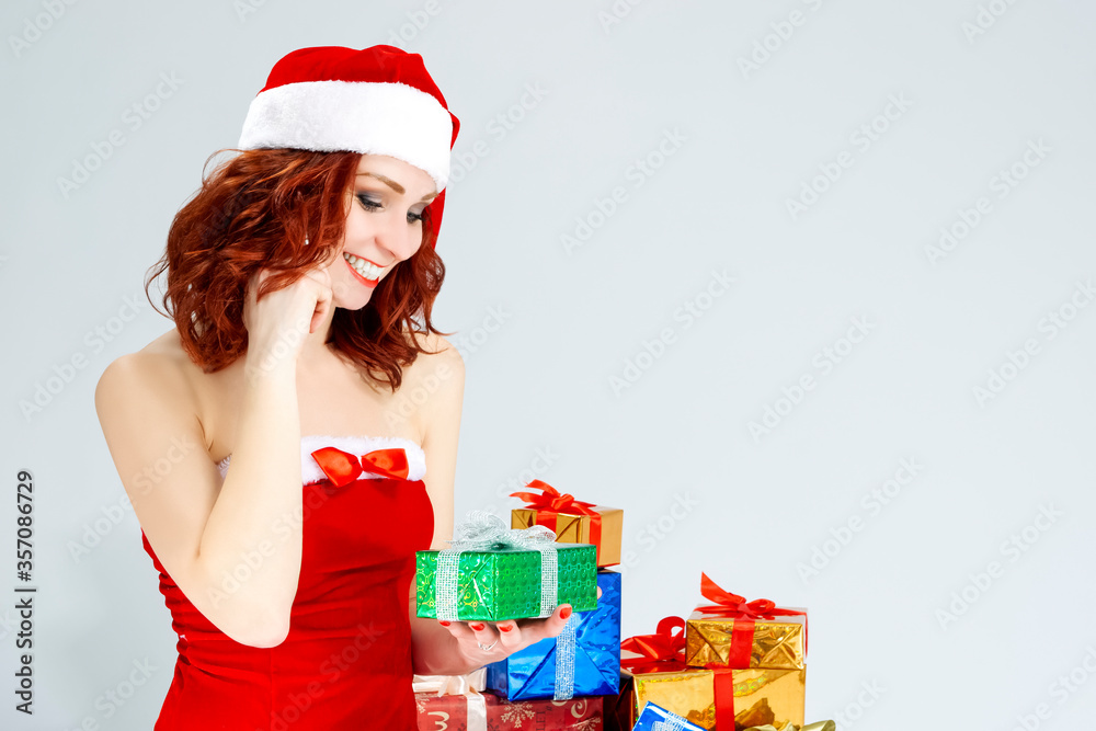 Christmas and New Year Ideas. Smiling Happy Snow Maiden with Lots of Christmas Presents. Against White Background Christmas and New Year Ideas. Smiling Happy Snow Maiden with Lots of Christmas Presents. Against White Background
