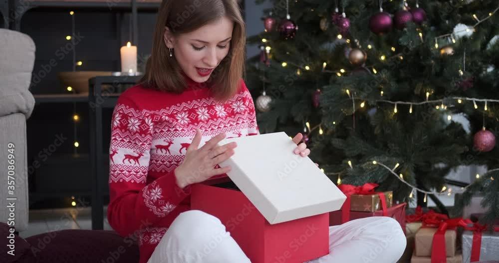 Excited woman astonished on receiving lingerie as Christmas present