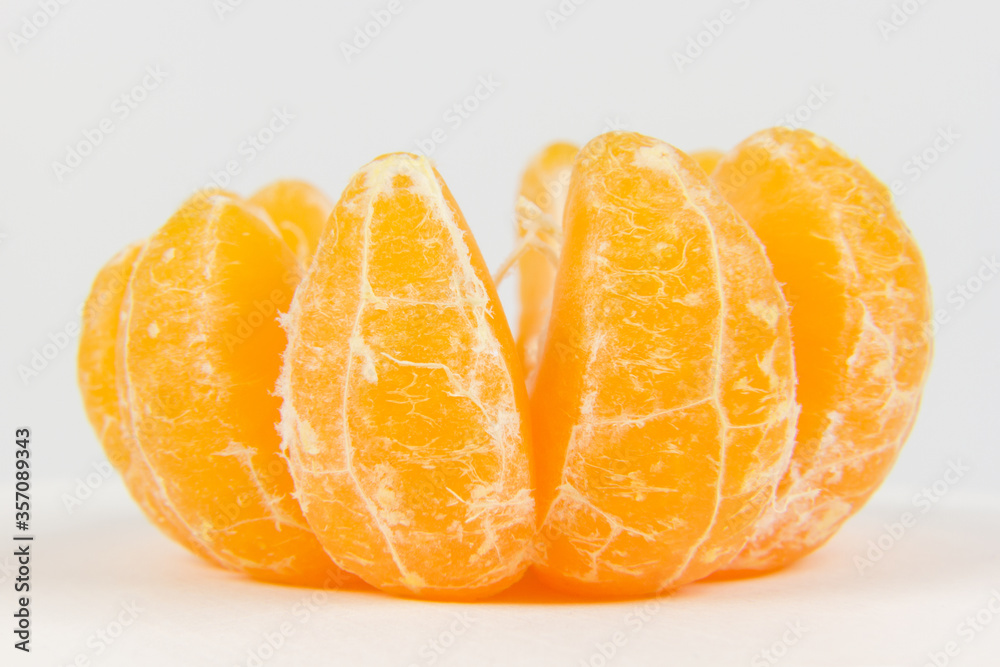 Peeled orange isolated on white background, macro shoot