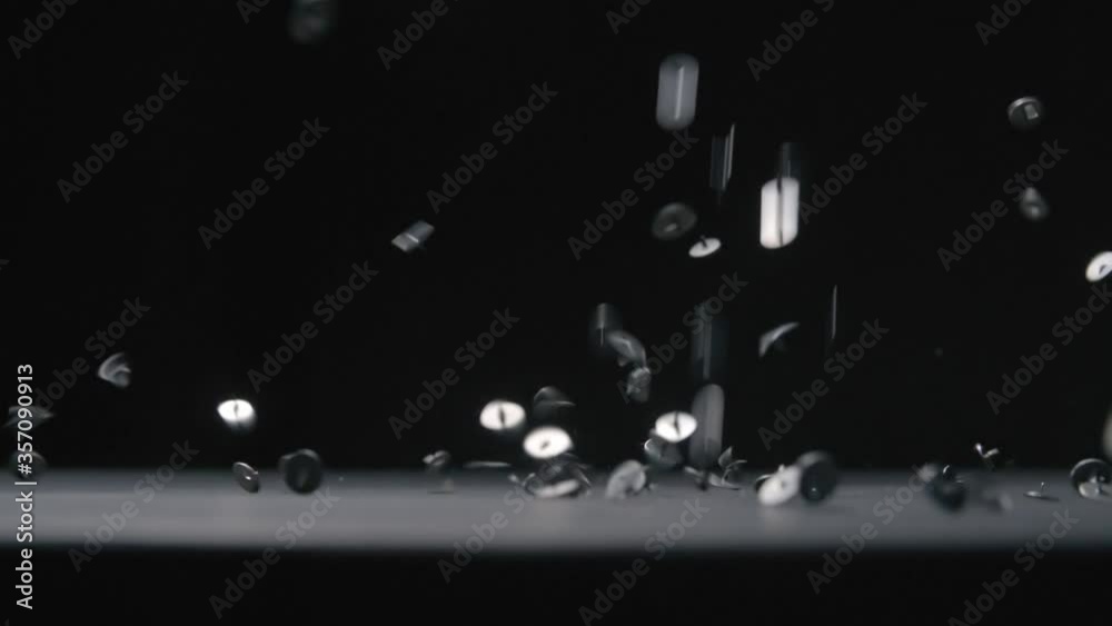 Metal pins falls on black background slow motion video. Metal pins falls on black background slow motion video.