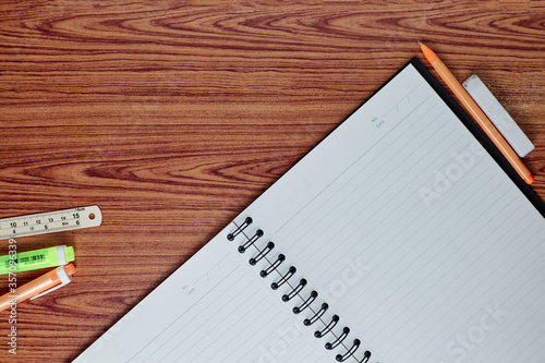 notebook and pen on wood table