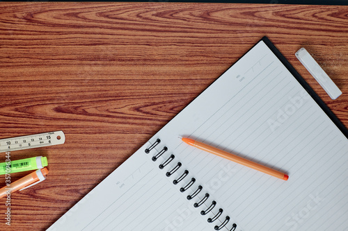 notebook and pen on wood table