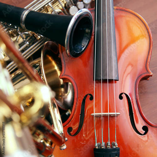 Closeup detail of classical musical instruments; violin, trumpet and clarinet 