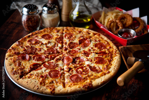 pepperoni pizza with french fries and onion rings