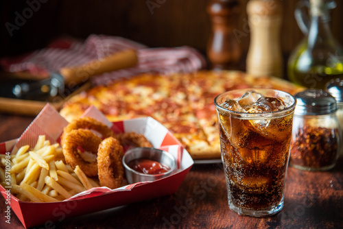 ice cold cola with pizza and french fries