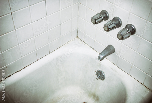 Dirty and moldy bathtub in a motel