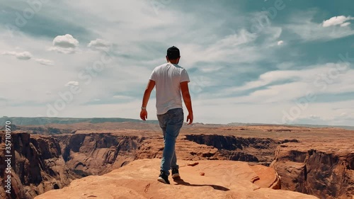 Following a male traveler to the edge of Horseshoe bend canyon, traveling around United States, another planet landscape