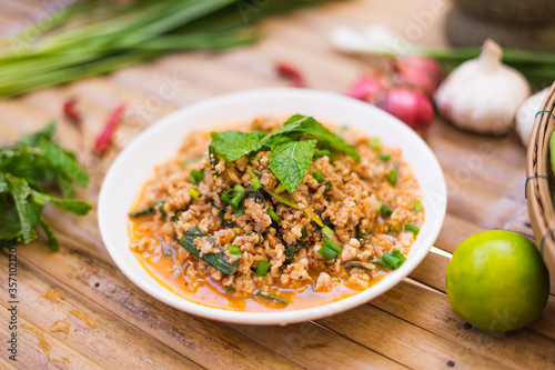 spicy minced meat salad on the wooden table,Thai food.
