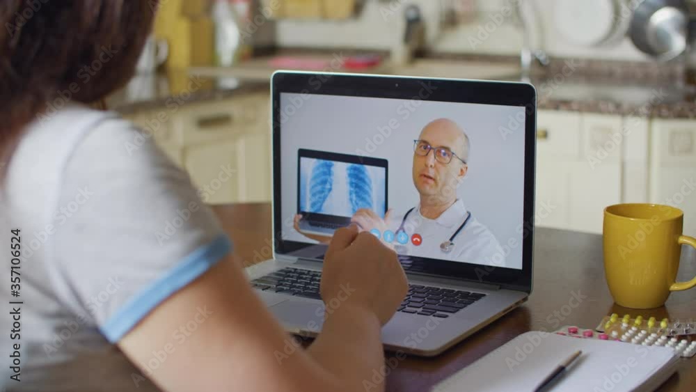 Practitioner doctor consulting by telemedicine online. Doctor explaining lung xray diagnosis by video call for patient. Patient consulting with medical specialist while coronavirus pneumonia Practitioner doctor consulting by telemedicine online. Doctor explaining lung xray diagnosis by video call for patient. Patient consulting with medical specialist while coronavirus pneumonia