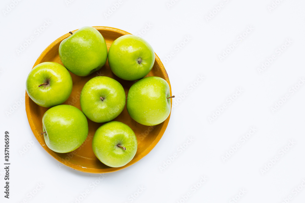 Fresh green apples on yellow plate on white background. Fresh green apples on yellow plate on white background.
