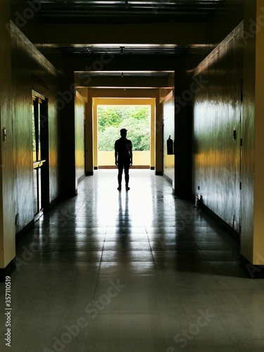 silhouette of a man in a corridor