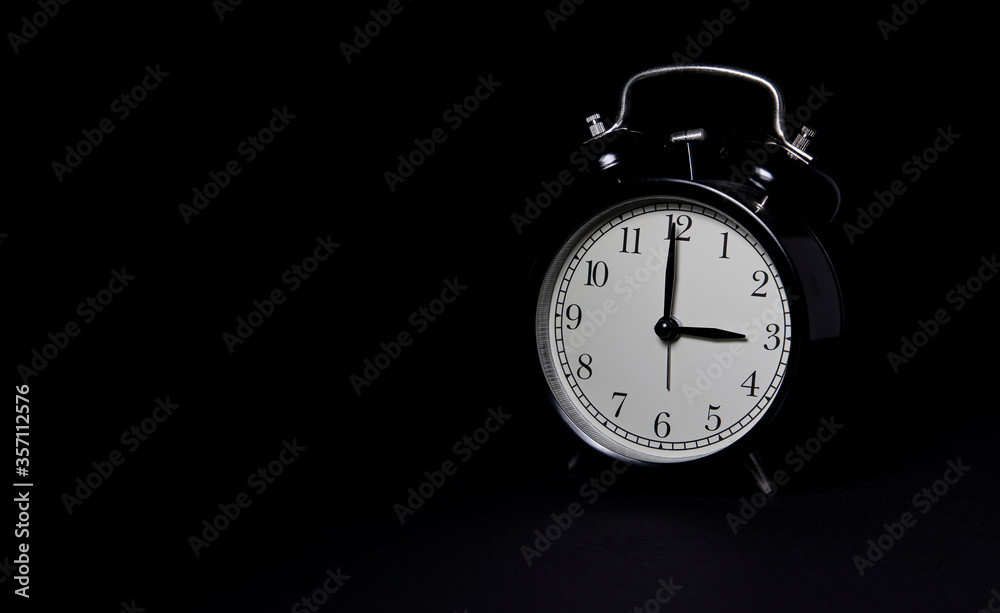 Black retro alarm clock on dark background. Night time. Black retro alarm clock on dark background. Night time.