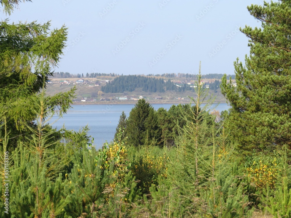 Landscape with a lake in the woods. the village road descends from the hill. Landscape with a lake in the woods. the village road descends from the hill.