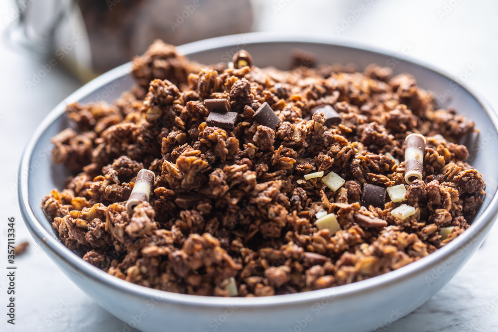 Jar of muesli with dark and milk cocolate pieces - closeup Jar of muesli with dark and milk cocolate pieces - closeup