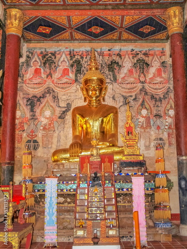 view of golden seated buddha statue in buddhist temple, Thai Lur style art 13th. Century., Wat Nong Bua, Tha Wang Pha District, Nan, northern of Thailand. © Yuttana Joe