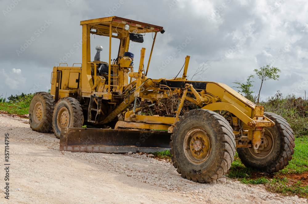 Parked Motor Grader On Construction Site Parked Motor Grader On Construction Site