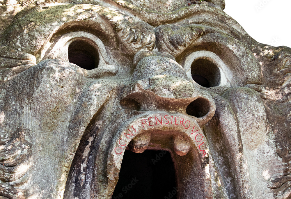 sixteenth century era volcanic rock statue of monster orcus with open big mouth in the village Bomarzo wood park close to Rome  
