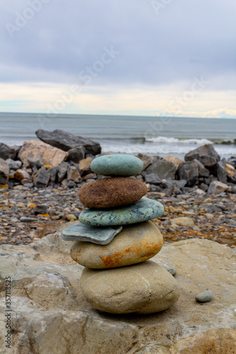 Pile of stones at Hokitika beach on a cloudy day, south island, New Zealand