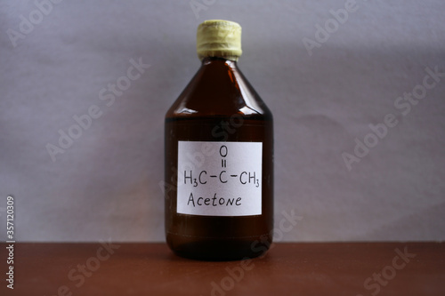 Glass bottle of dark glass with acetone. photo