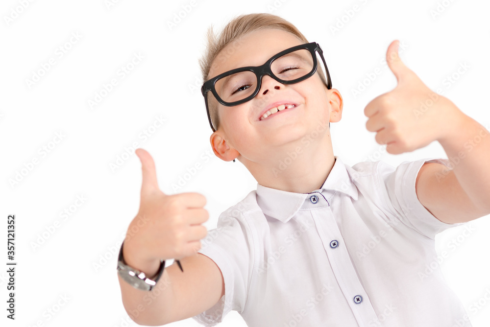 Portrait of atractive elementary school student showing his thumbs up on isolated white background Portrait of atractive elementary school student showing his thumbs up on isolated white background