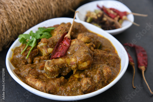 Chettinad chicken curry is a hot and spicy dish Tamil Nadu, South India. Gravy prepared from roast and ground Indian spices,coconut or garam masala for meat / non-vegetarian recipe/ cuisine. photo