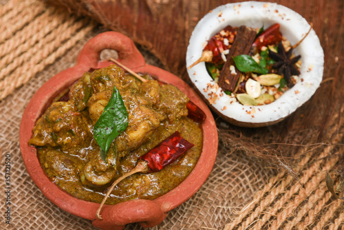 Chettinad chicken curry is a hot and spicy dish Tamil Nadu, South India. Gravy prepared from roast and ground Indian spices,coconut or garam masala for meat / non-vegetarian recipe/ cuisine. photo