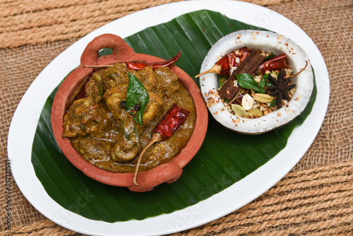 Chettinad chicken curry is a hot and spicy dish Tamil Nadu, South India. Gravy prepared from roast and ground Indian spices,coconut or garam masala for meat / non-vegetarian recipe/ cuisine. photo