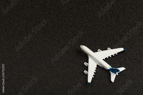 Model airplane on black background. Top view. Toy plane